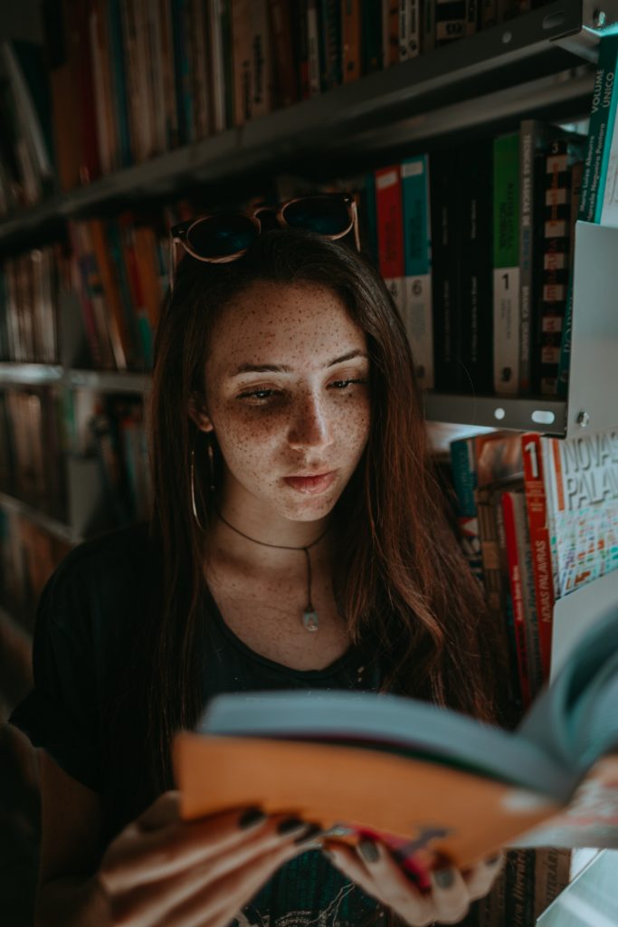 Woman reading a book reading statistics